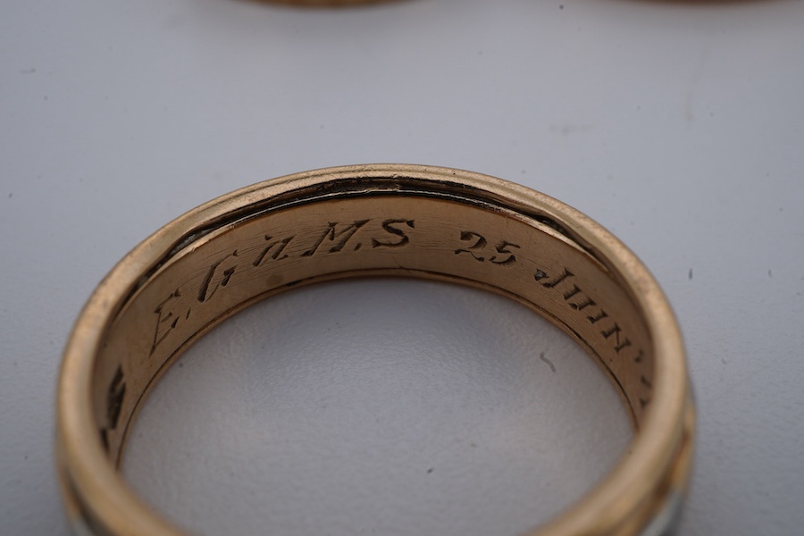 Four gold rings, comprising: a 22ct gold wedding band, size M, British assay marks, gross weight 3 grams; a 9ct gold band with a panelled finish, size N, British hallmarks, gross weight approximately 3.5 grams; a bicolou